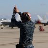 A flight line sailor brings in the F-35s.